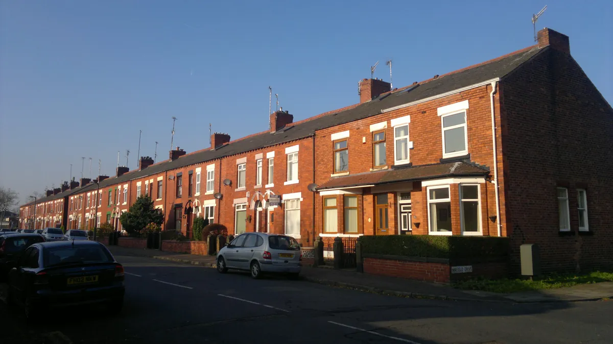 Red-brick terraced houses in evening sun on Durnford Street in Middleton